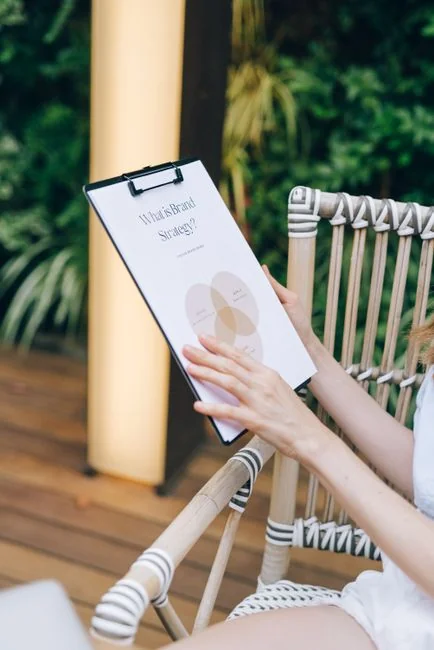 A person is holding a smartphone and browsing the SumUp Instagram profile.
